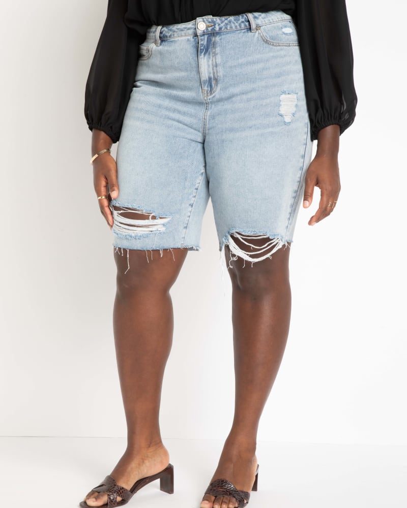 Front of a model wearing a size 22 City Shorts in Light Wash by ELOQUII. | dia_product_style_image_id:284404